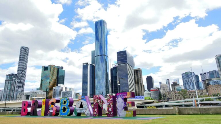 Brisbane city skyline with colorful South Bank sign.