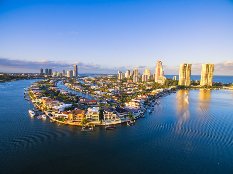 Aerial view of Gold Coast cityscape with waterfront and high-rise buildings.