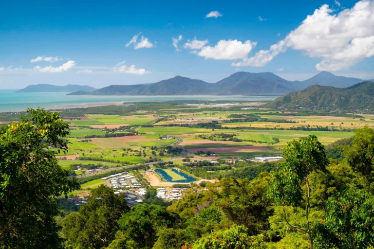 Scenic view of Cairns with mountains and fields.