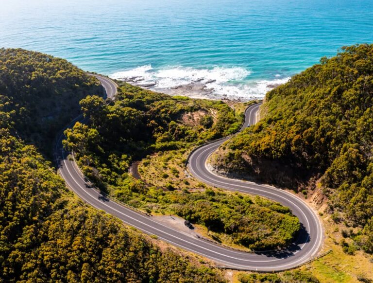 Aerial view of the winding Great Ocean Road along the coast.
