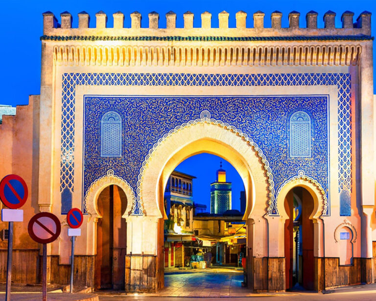 Bab Bou Jeloud, the Blue Gate in Fez, Morocco, illuminated at night.