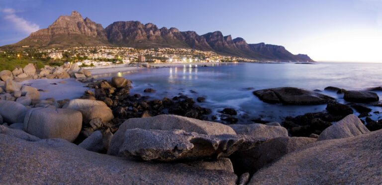 Scenic view of the Twelve Apostles mountains at sunset from the beach in Cape Town.