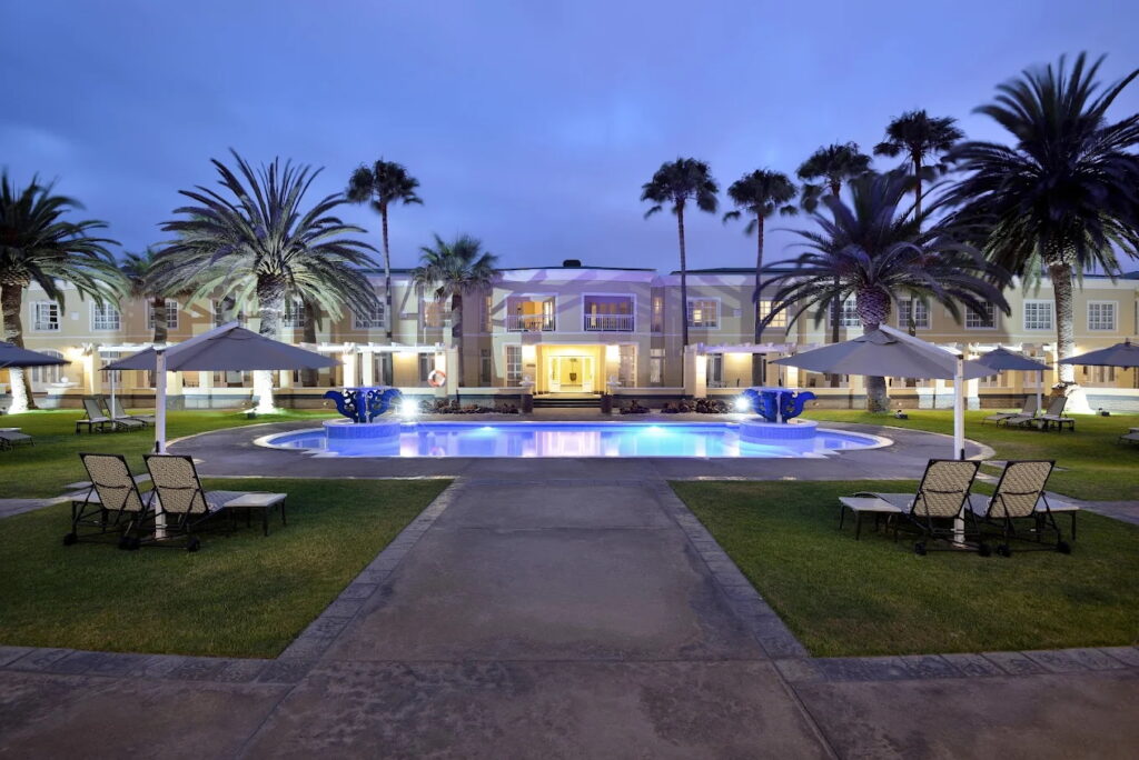 Luxury hotel with pool and palm trees in Swakopmund, Namibia.