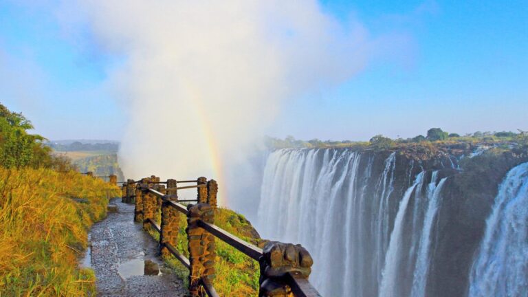 Victoria Falls with a rainbow and pathway