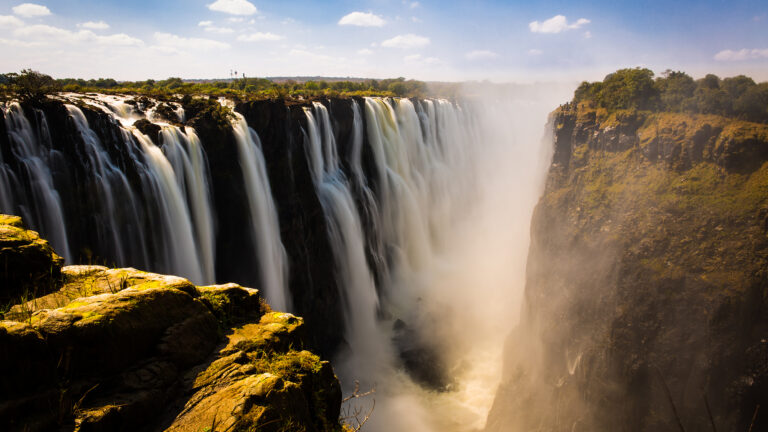 Aerial view of Victoria Falls with mist rising.