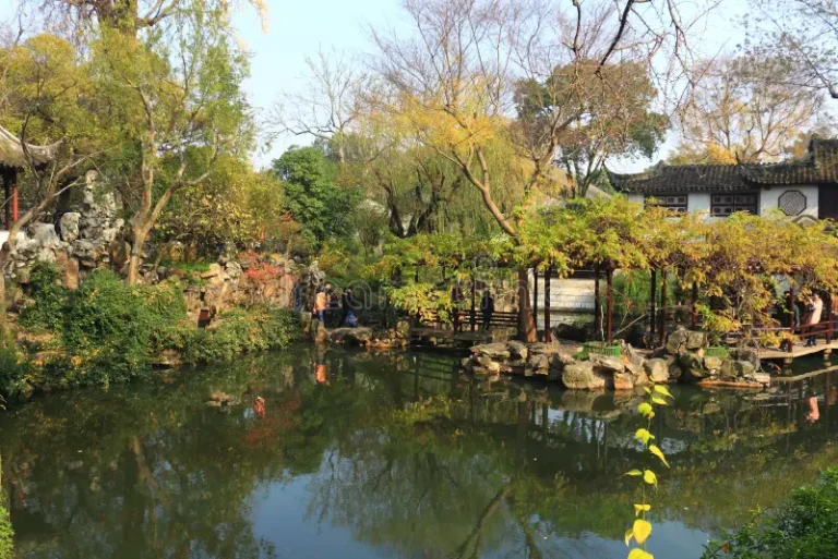 Traditional Chinese garden with pond and trees in Suzhou.