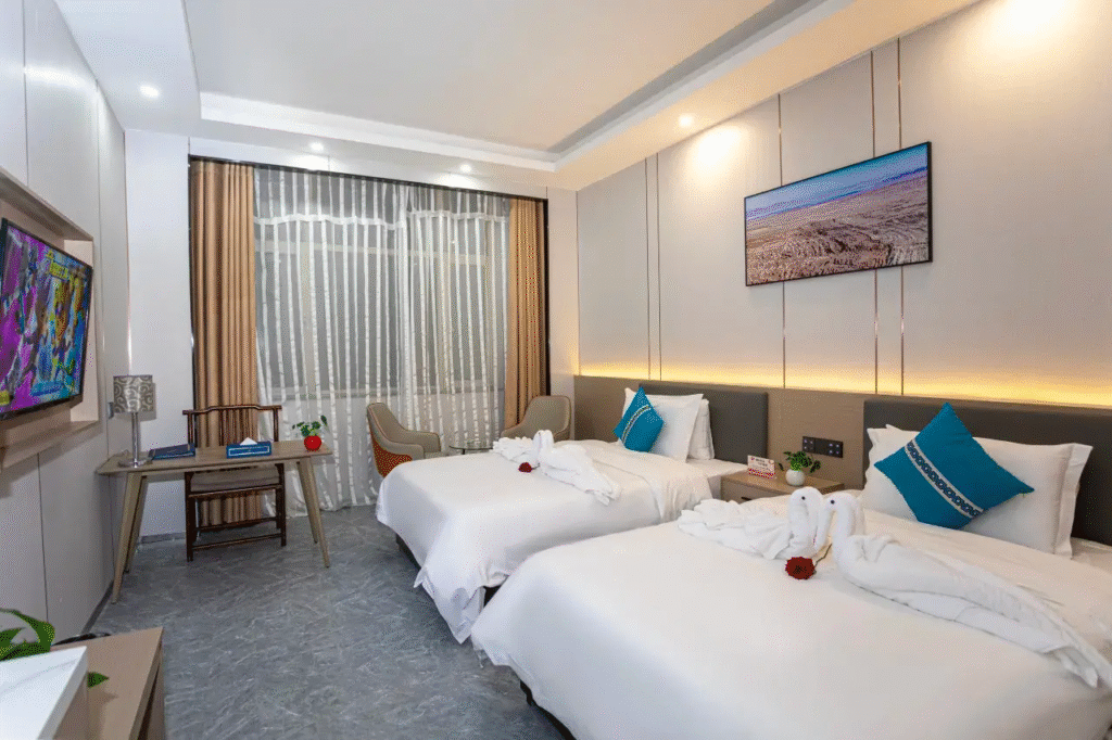 Modern hotel room with twin beds and decor