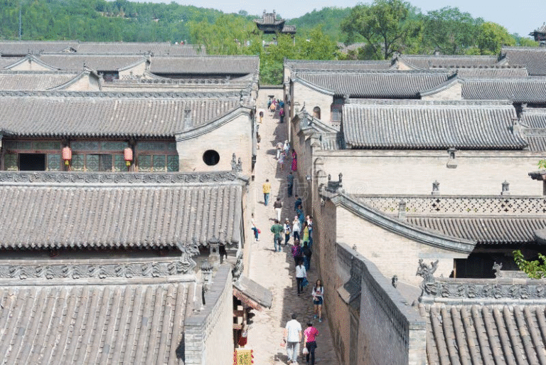 Aerial view of Wang Family Courtyard with tourists walking.