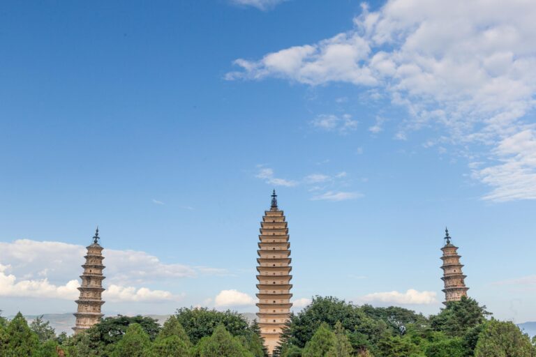 Three Pagodas of Chongsheng Temple under a blue sky.