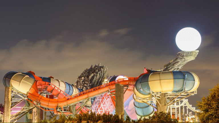 Night view of water slides at a UAE theme park