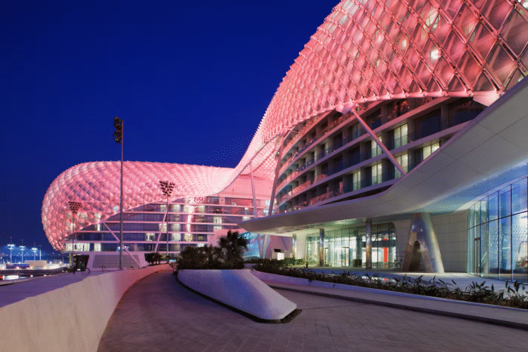 Yas Hotel Abu Dhabi illuminated at night.