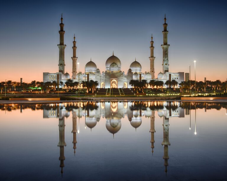 Sheikh Zayed Grand Mosque at sunset with reflection in water