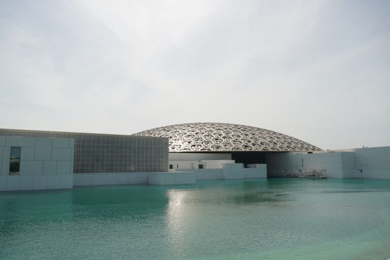 Louvre Abu Dhabi with its iconic dome over water.