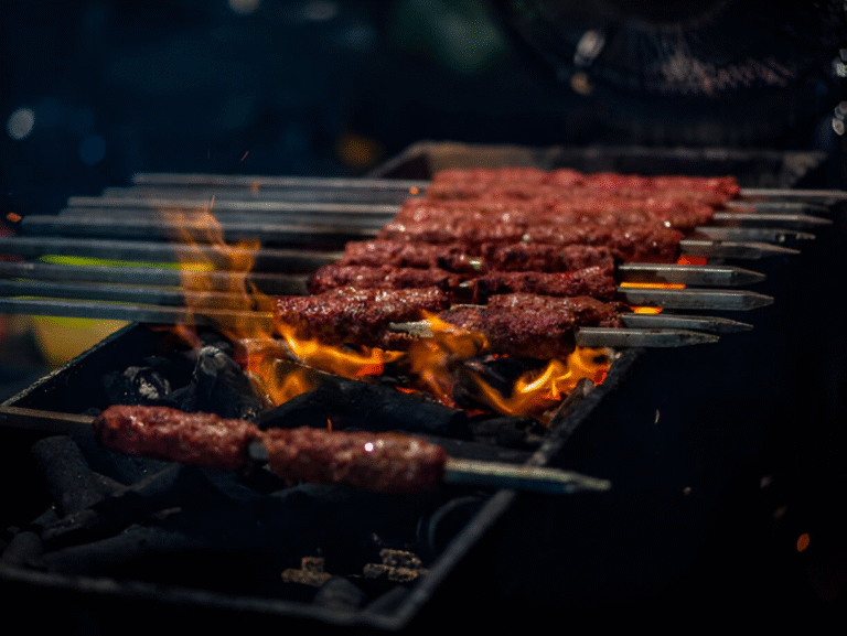Skewers grilling over open flames at a barbecue.