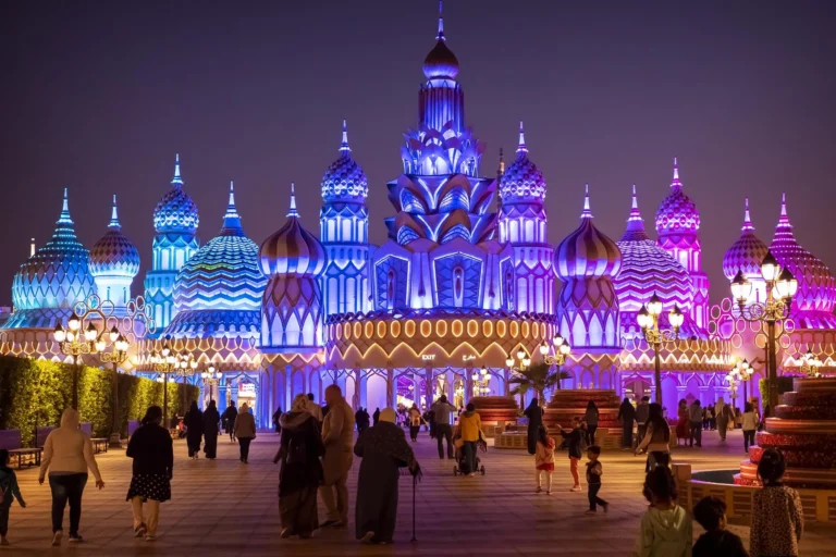 Illuminated domes at Global Village in Dubai at night.