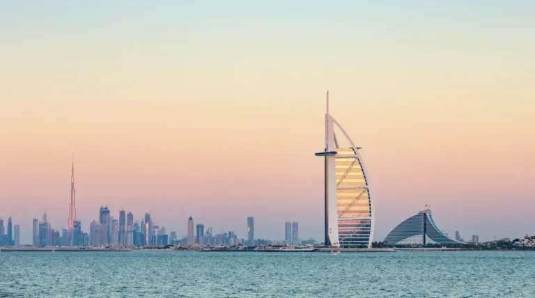 Burj Al Arab with Dubai skyline at sunset