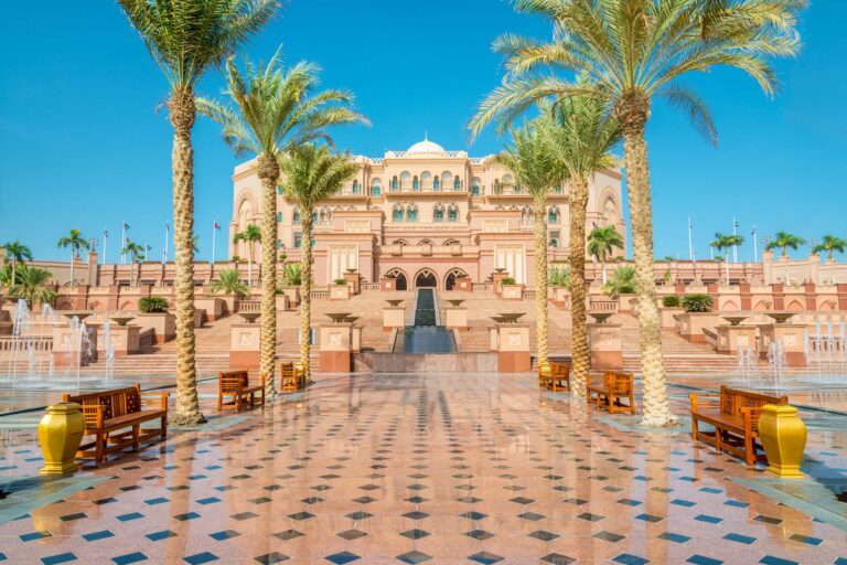 Emirates Palace entrance with palm trees and fountain