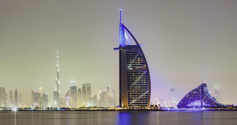 Night view of Burj Al Arab and Dubai skyline
