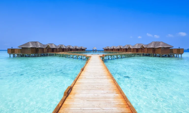 Overwater bungalows in the Maldives with a wooden walkway.