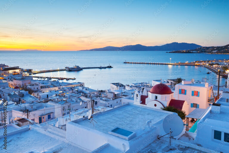 Sunset view of Mykonos harbor and church