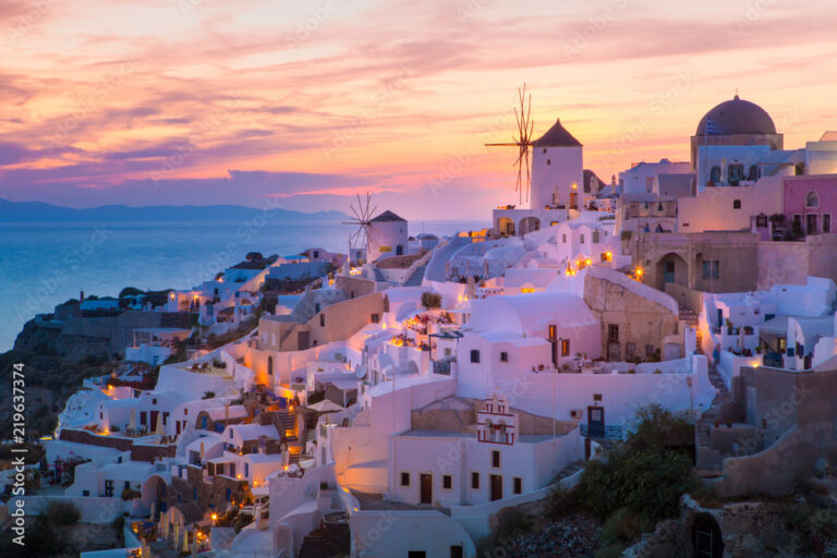 Oia village at sunset with white buildings and a windmill