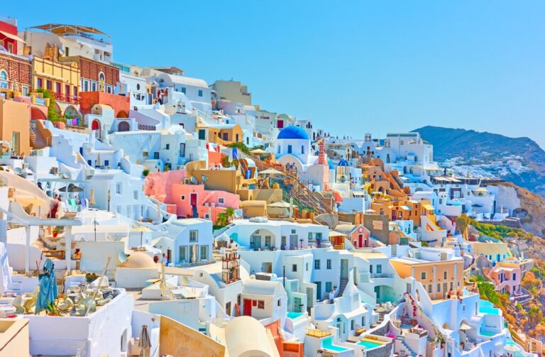 Colorful buildings in Santorini, Greece overlooking the Aegean Sea.