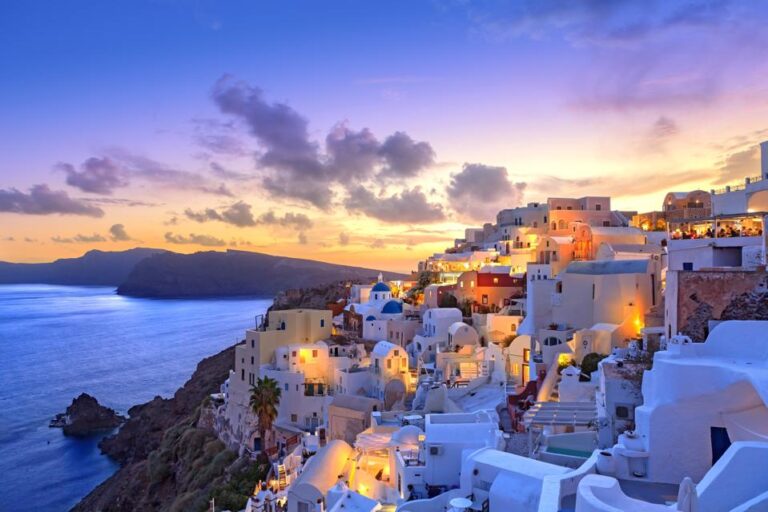 Sunset view of Santorini's white buildings and sea.