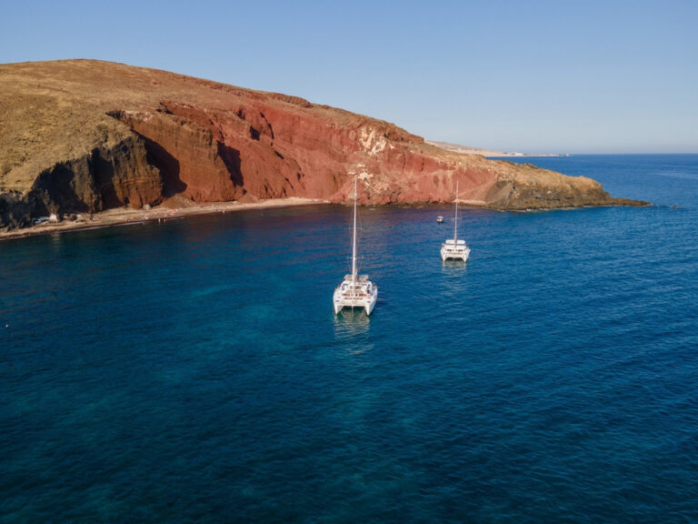 Catamarans anchored near Red Beach in Santorini