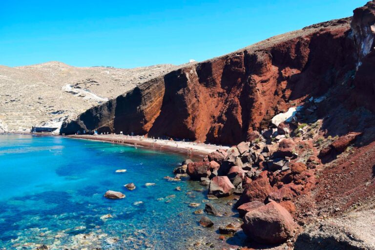 Red Beach in Santorini with tourists sunbathing