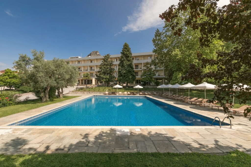 Hotel with swimming pool in Greece surrounded by trees