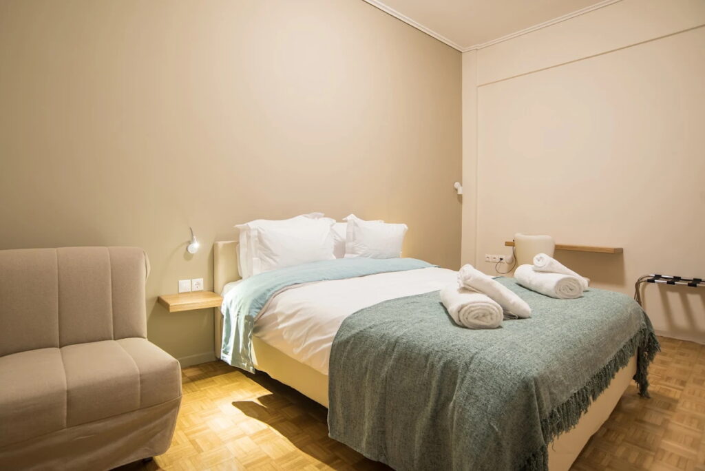 Modern hotel room with comfortable bed and cozy decor