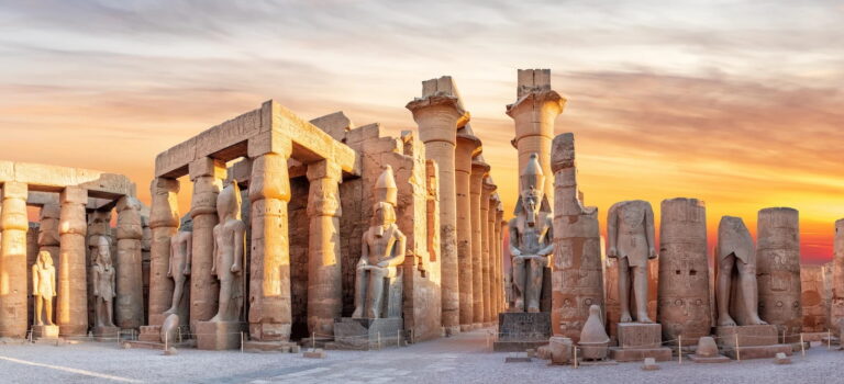 Luxor Temple with ancient statues and columns at sunset