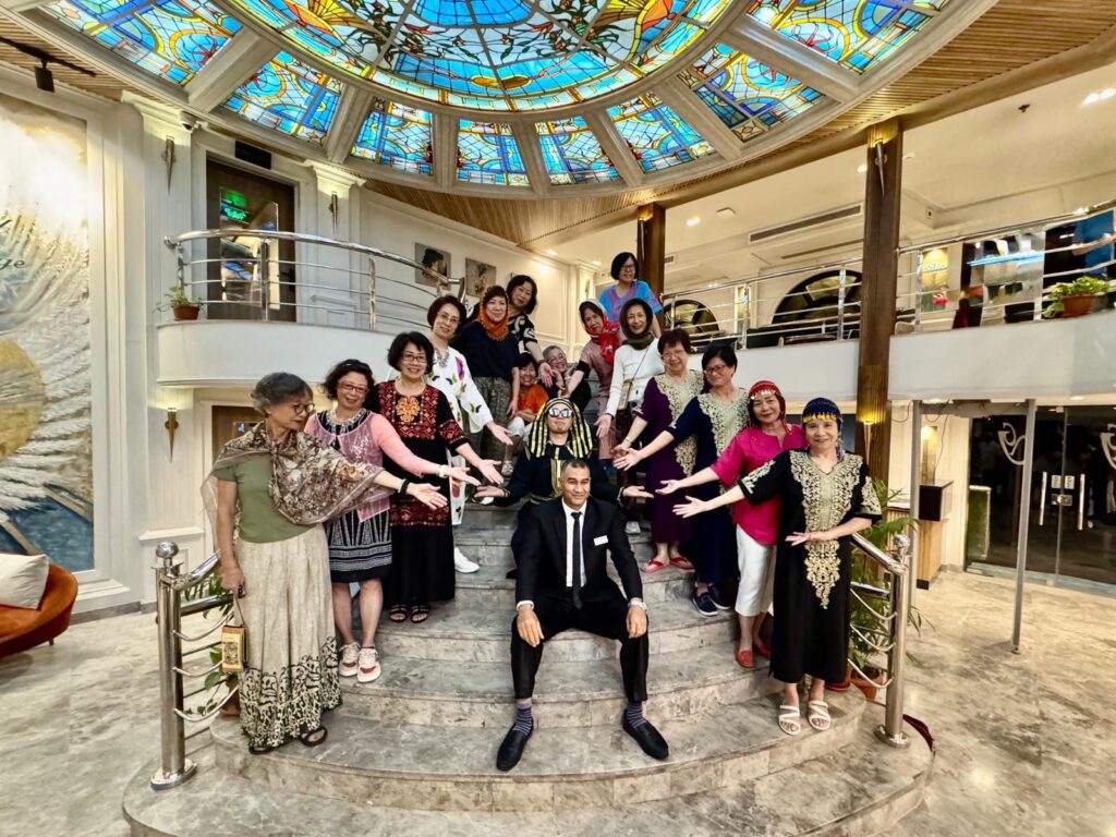Group of travelers posing on a staircase inside a Nile cruise ship