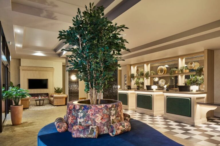 Lobby of Leonardo Hotel in Edinburgh with plants and seating.