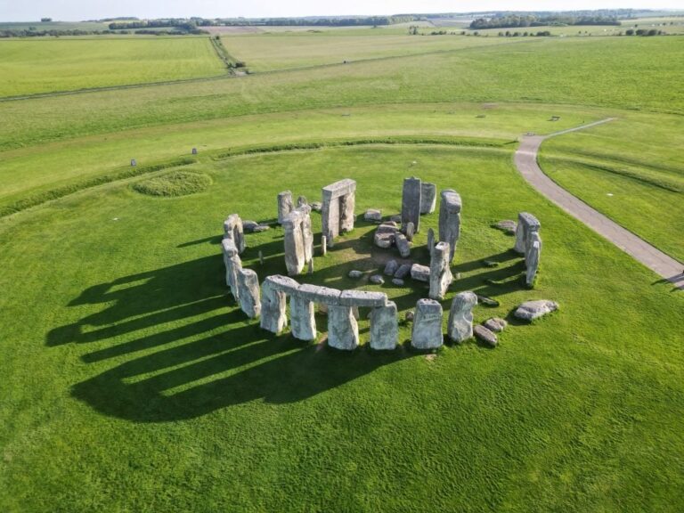 Aerial view of Stonehenge surrounded by green fields.