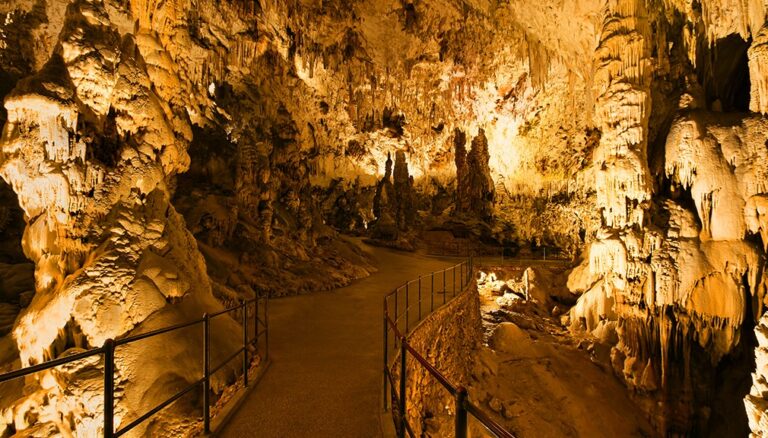 Inside Postojna Cave with illuminated stalactites and stalagmites