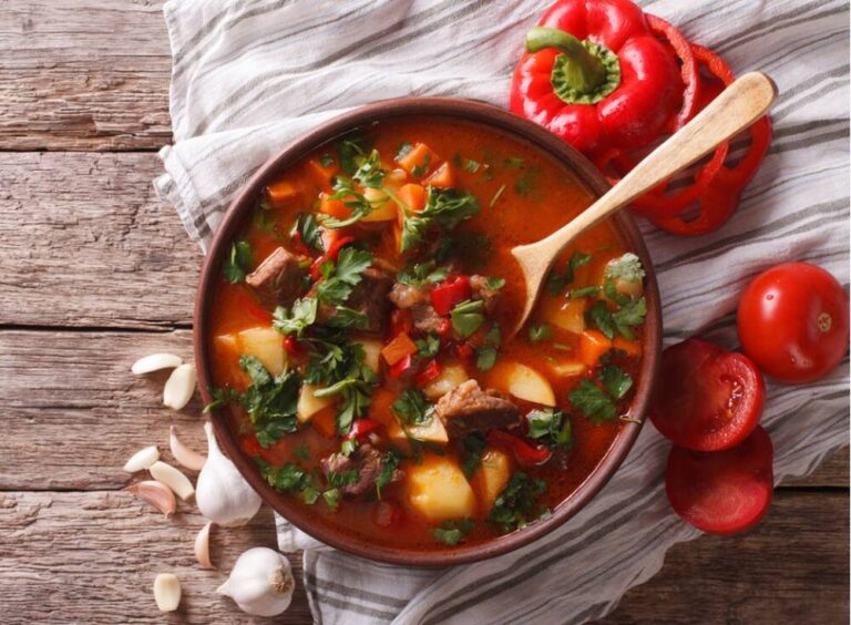 Bowl of traditional Hungarian goulash with vegetables.