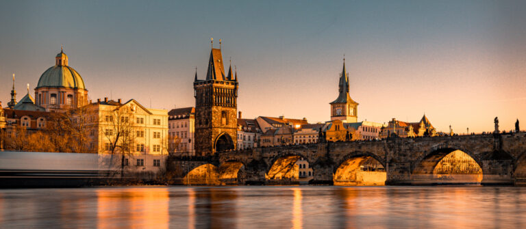 Charles Bridge over Vltava River at sunset in Prague
