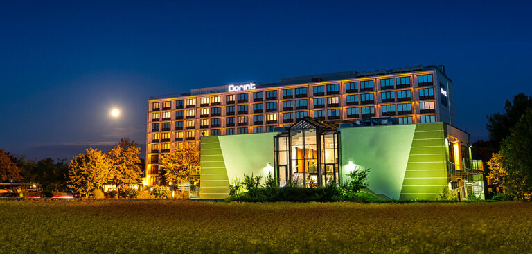 Dorint Hotel Main-Taunus illuminated at night.