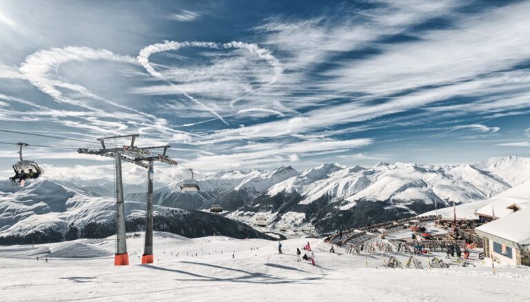 Ski resort in Davos, Switzerland with ski lift and snowy mountains.