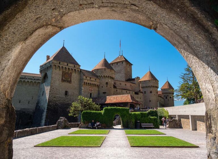 Chillon Castle in Switzerland under a stone archway