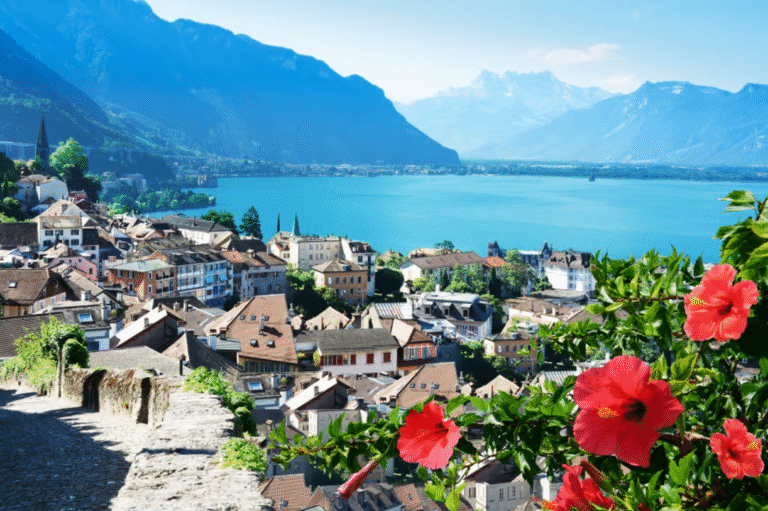 View of Montreux and Lake Geneva with red flowers in the foreground