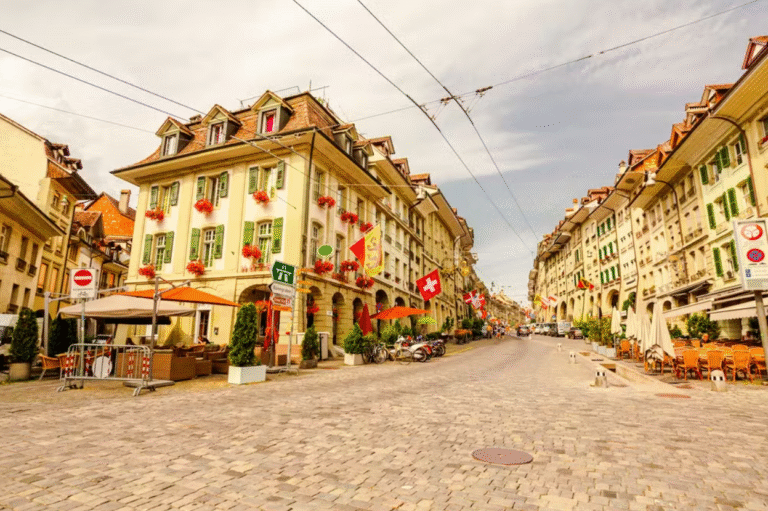 Historic street in Bern, Switzerland with outdoor cafes.