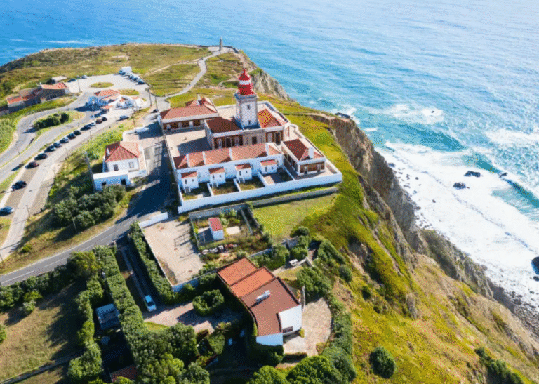 Aerial view of Cabo da Roca lighthouse on a cliff.
