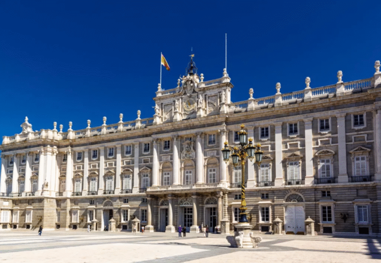 Royal Palace of Madrid under a clear blue sky.