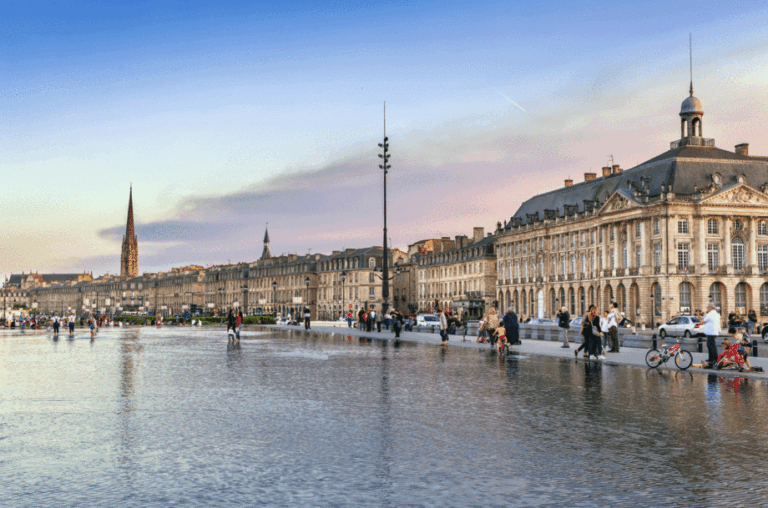 Evening view of Place de la Bourse and Miroir d'eau in Bordeaux.