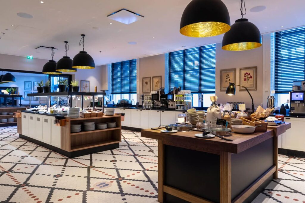 Hotel breakfast buffet area with modern interior design.