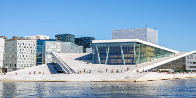 Oslo Opera House with modern architecture by the waterfront.