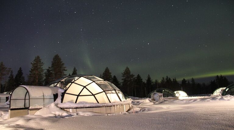Glass igloos under the northern lights.