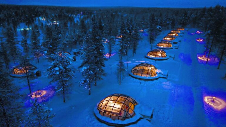 Glass igloos in snowy Finnish Lapland at night.